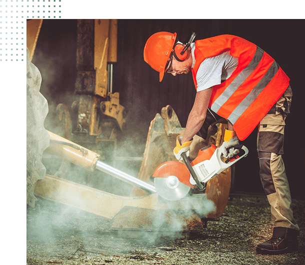 A man in an orange vest using a chain saw.